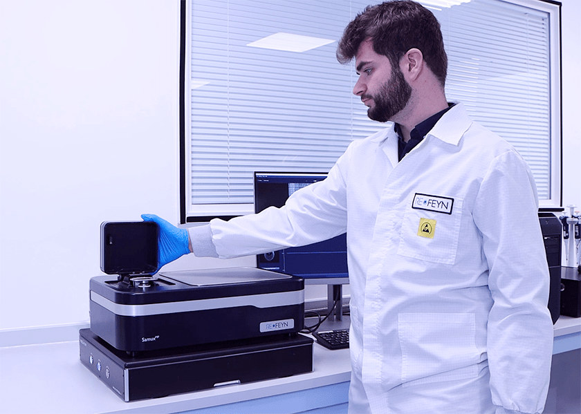 A researcher opening the cover of the sample loading area on a SamuxMP mass photometer